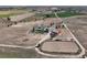 Extensive aerial view of the property with a house, barn, paddock and surrounding fields at 10691 County Road 23, Fort Lupton, CO 80621