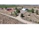 An aerial view of the house, barn, and land that makes up the expansive property at 10691 County Road 23, Fort Lupton, CO 80621