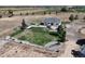 An aerial view shows the home, yard and surrounding farmland, with a fenced back yard at 10691 County Road 23, Fort Lupton, CO 80621