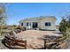 Charming backyard patio area with stone pavers, wooden fence and a view of the property at 10691 County Road 23, Fort Lupton, CO 80621