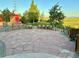 Spacious backyard patio with stone flooring and comfortable seating, ideal for outdoor enjoyment at 10691 County Road 23, Fort Lupton, CO 80621