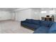 Spacious finished basement features a large sectional couch, neutral carpet, and a work space at 10691 County Road 23, Fort Lupton, CO 80621