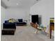 Finished basement boasts a comfortable seating area and entertainment setup at 10691 County Road 23, Fort Lupton, CO 80621