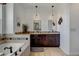 A large bathroom with double sinks, dark wood cabinets, and a relaxing soaking tub at 10691 County Road 23, Fort Lupton, CO 80621