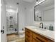 Beautiful bathroom features a stone tile shower, wood vanity and modern fixtures at 10691 County Road 23, Fort Lupton, CO 80621
