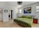 A bright bedroom with hardwood floors, a stylish bed frame, and a mountain painting at 10691 County Road 23, Fort Lupton, CO 80621