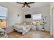Bright bedroom features light hardwood floors, white walls, and a ceiling fan at 10691 County Road 23, Fort Lupton, CO 80621