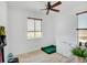 Clean, well-lit bedroom features a window, hardwood floors, and a ceiling fan at 10691 County Road 23, Fort Lupton, CO 80621