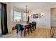 Well-lit dining room features a wooden table, a decorative chandelier, and lots of natural light at 10691 County Road 23, Fort Lupton, CO 80621
