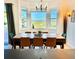 Well-lit dining room featuring mountain views and an elegant chandelier fixture at 10691 County Road 23, Fort Lupton, CO 80621