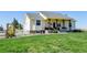Charming one-story home with a covered front porch and well-maintained lawn at 10691 County Road 23, Fort Lupton, CO 80621