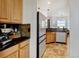 Modern kitchen with stainless steel appliances, wooden cabinetry, and a tile backsplash at 10691 County Road 23, Fort Lupton, CO 80621