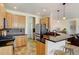 Updated kitchen boasts stainless steel appliances, granite countertops, and hardwood floors, perfect for cooking and entertaining at 10691 County Road 23, Fort Lupton, CO 80621