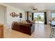 Inviting living room with a modern fireplace, wood floors, and expansive windows to enjoy the outdoor view at 10691 County Road 23, Fort Lupton, CO 80621