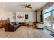 Inviting living room with a cozy fireplace, wood floors, and abundant natural light from a large window at 10691 County Road 23, Fort Lupton, CO 80621