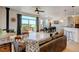 Open-concept living space featuring hardwood floors, a fireplace, and a sliding glass door with backyard views at 10691 County Road 23, Fort Lupton, CO 80621