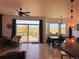Open concept living area with a dining area, ceiling fan, and sliding glass doors to the patio, perfect for gatherings at 10691 County Road 23, Fort Lupton, CO 80621