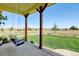 Inviting porch with a swing, providing a relaxing space to enjoy the peaceful surroundings at 10691 County Road 23, Fort Lupton, CO 80621
