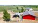 Scenic view of rural property with multiple outbuildings, expansive green fields, and distant views at 10691 County Road 23, Fort Lupton, CO 80621