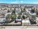 Aerial view of a charming neighborhood featuring a home, shed, and level area, all under a clear blue sky at 335 Jefferson St, Monument, CO 80132