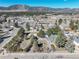 Scenic aerial view featuring the home, level area, and a neighborhood with mountain views in the distance at 335 Jefferson St, Monument, CO 80132