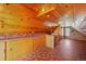 Spacious attic with wood-paneled walls and ceilings, complete with a sink and countertop at 335 Jefferson St, Monument, CO 80132