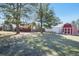 Expansive backyard featuring a large shed, a spacious lawn, and mature trees, offering privacy and space at 335 Jefferson St, Monument, CO 80132