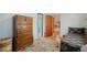 Bedroom with hardwood floors, a chest of drawers, and a view into an adjoining room with a tiled floor at 335 Jefferson St, Monument, CO 80132