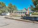 Charming property with lush trees, unique stone accents, wishing well, and grazing deer at 335 Jefferson St, Monument, CO 80132