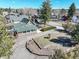Charming home with lush green yard, water well feature, mature trees, and beautiful stone accents at 335 Jefferson St, Monument, CO 80132