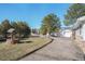 Charming home featuring a well, mature trees, and a detached two-car garage, all under a clear blue sky at 335 Jefferson St, Monument, CO 80132