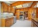 Spacious wood kitchen with stainless appliances, granite countertops and skylight offering an abundance of natural light at 335 Jefferson St, Monument, CO 80132