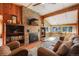 Cozy living room with stone fireplace, hardwood floors and lots of natural light at 335 Jefferson St, Monument, CO 80132