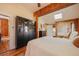 Spacious main bedroom featuring hardwood flooring, a ceiling fan, a wardrobe, and access to an adjoining bathroom at 335 Jefferson St, Monument, CO 80132