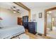 Bright main bedroom with a ceiling fan, hardwood flooring, a wardrobe, a dresser, and an en suite bathroom at 335 Jefferson St, Monument, CO 80132