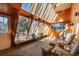Bright sunroom with wooden accents, stone floors, and a wall of windows offering lovely views at 335 Jefferson St, Monument, CO 80132