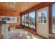 Bright sunroom features wood paneling, windows and access to the outdoors at 335 Jefferson St, Monument, CO 80132