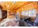 Bright sunroom with lots of windows and wood paneling provides a cozy place to relax at 335 Jefferson St, Monument, CO 80132