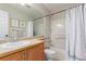 Bright bathroom featuring a vanity, a toilet, a tub with a shower, and modern finishes at 3525 E 139Th Pl, Thornton, CO 80602