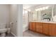 Bright bathroom featuring a vanity, a toilet, a tub with a shower, and modern finishes at 3525 E 139Th Pl, Thornton, CO 80602