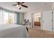 Bright bedroom featuring a work desk, large window, and an ensuite bathroom at 3525 E 139Th Pl, Thornton, CO 80602