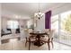 Bright dining area with a round table, stylish chandelier, and sliding glass doors to the outside at 3525 E 139Th Pl, Thornton, CO 80602