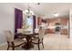 Charming dining area with a round table, chandelier, and adjacent kitchen, perfect for intimate meals and gatherings at 3525 E 139Th Pl, Thornton, CO 80602