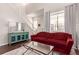 Bright living room featuring a staircase, large window, and comfortable seating arrangement with modern decor at 3525 E 139Th Pl, Thornton, CO 80602