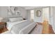 Bright bedroom with ensuite access and a decorative gold mirror on the wall at 14399 E Grand Dr # 150, Aurora, CO 80015