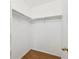 Walk-in closet with rods for hanging clothes and hardwood floors at 14399 E Grand Dr # 150, Aurora, CO 80015