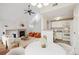 Spacious living room flows into a bright kitchen with white cabinets and modern appliances at 14399 E Grand Dr # 150, Aurora, CO 80015