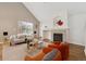 Bright living room features a vaulted ceiling and cozy fireplace, perfect for relaxation at 14399 E Grand Dr # 150, Aurora, CO 80015