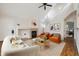 Open-concept living room with a fireplace, hardwood floors, and modern accents at 14399 E Grand Dr # 150, Aurora, CO 80015