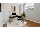 Bright office space with arched window, modern desk setup, wood floors, and minimalist decor at 14399 E Grand Dr # 150, Aurora, CO 80015